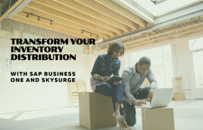 Two business professionals working with laptop and tablet in modern warehouse setting with exposed wooden beams and shipping boxes, promoting SAP Business One and SkySurge inventory distribution solutions